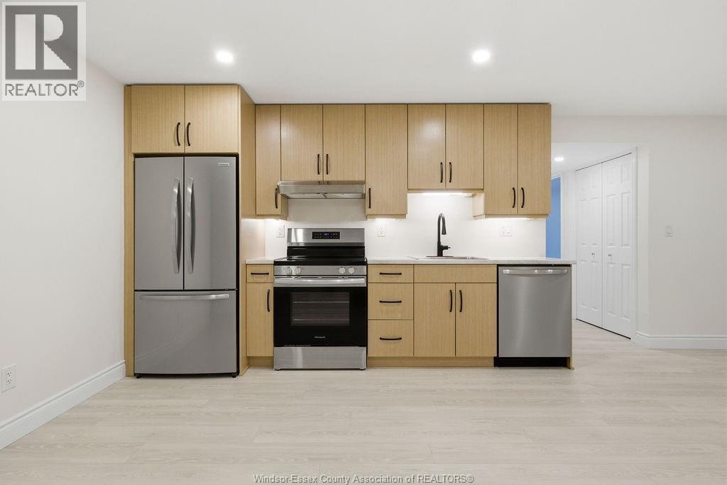 Lower-level kitchen with stainless appliances